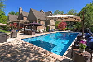 Swimming pool with an outdoor living space, a pergola, a patio, and a gazebo
