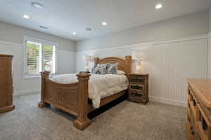 Bedroom featuring carpet, wainscoting, and recessed lighting