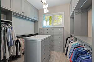 Spacious closet featuring a chandelier
