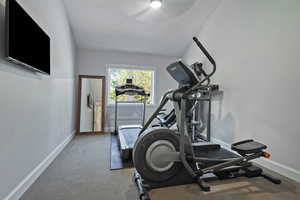 Exercise room featuring carpet and baseboards