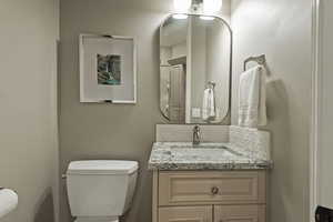Half bathroom with toilet and vanity