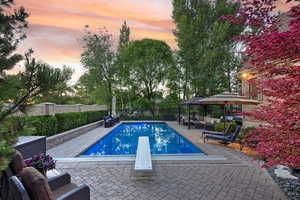 View of swimming pool with an outdoor hangout area, a patio, a diving board, and a fenced backyard