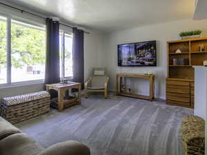 Sitting room with carpet and baseboards