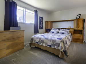 Carpeted bedroom featuring baseboards