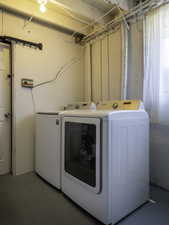 Washroom with washing machine and clothes dryer