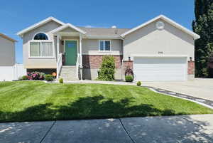 Ranch-style home featuring brick siding, stucco siding, concrete driveway, and an attached garage