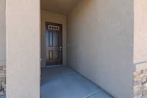 View of exterior entry featuring stucco siding