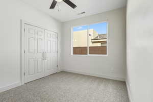 Unfurnished bedroom with light carpet, a closet, and ceiling fan