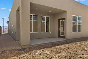 Rear view of property featuring a patio area, stucco siding, and a mountain view
