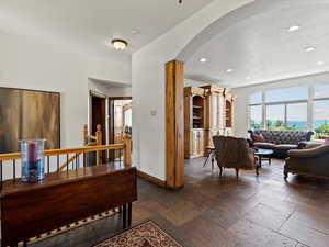 Entry landing with arched details to living room, with lake and mountain views