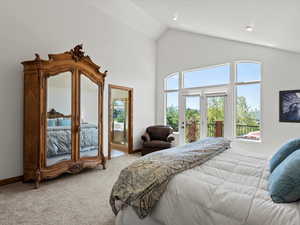 Bedroom featuring carpet flooring, access to outside, multiple windows, high vaulted ceiling, and french doors
