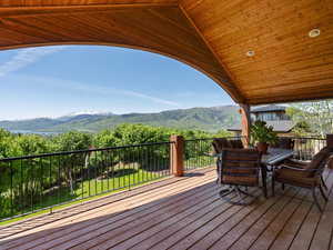 Covered deck / outdoor dining space with views of Pineview Reservoir and Snowbasin ski resort