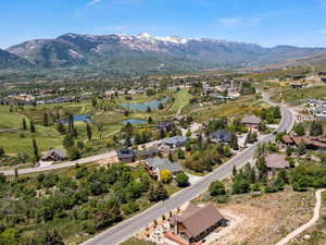 Aerial view of residential area featuring lake and mountain views with adjacent Wolf Creek  golf course.
