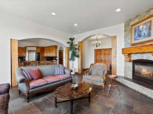 Living room with arched details to kitchen and hall