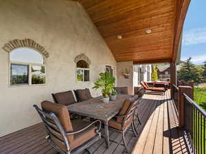 Outdoor dining space off of kitchen, with lake and mountain views