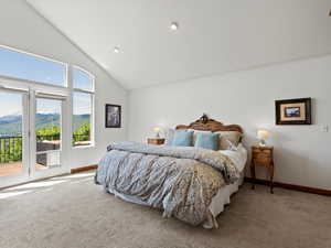 Bedroom featuring carpet floors, access to exterior, mountain and lake views