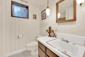 Bathroom featuring vanity, toilet, and tile patterned floors