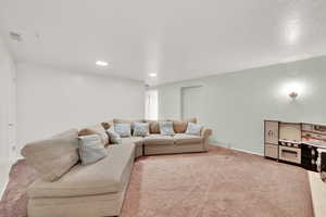 Carpeted living area featuring baseboards