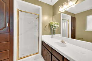Bathroom with vanity and a shower stall