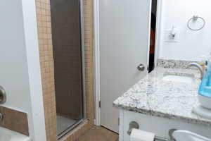 Full bathroom with a shower stall and vanity