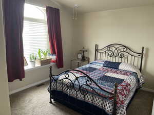 Carpeted bedroom with baseboards