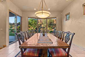 Dining area with stone tile flooring, plenty of natural light, recessed lighting, and baseboards