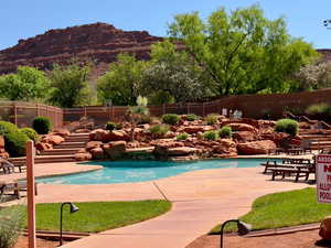 Community pool featuring a mountain view and a patio area