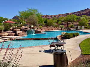 Community pool featuring a patio and a mountain view