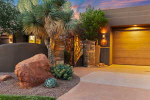 View of front of home with a gate and stucco siding