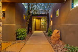 Entrance to property with stucco siding