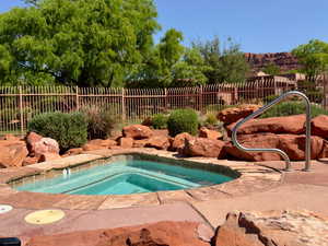 View of swimming pool featuring an in-ground hot tub