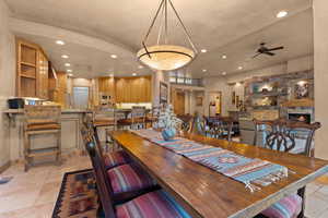 Dining area with recessed lighting, a ceiling fan, baseboards, and a stone fireplace