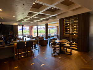 Dining room with coffered ceiling, recessed lighting, wood finished floors, and beam ceiling