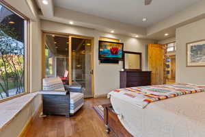 Bedroom with recessed lighting, wood finished floors, and access to outside