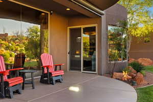 View of patio with an outdoor fire pit
