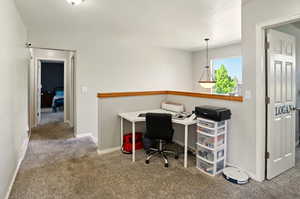 Carpeted home office with baseboards