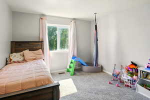 Bedroom featuring carpet flooring and baseboards