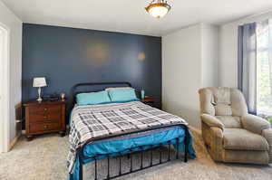 Bedroom with carpet flooring, multiple windows, and baseboards
