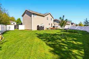 Back of property featuring a trampoline