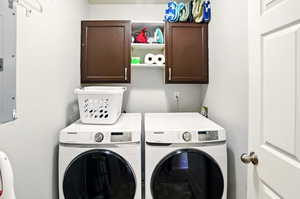Laundry area with cabinet space and washing machine and dryer