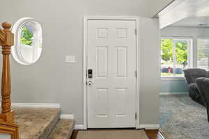 Entrance foyer with baseboards and stairway