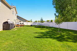 View of yard with a trampoline