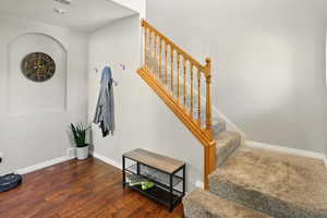 Stairway with baseboards and wood finished floors