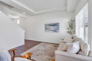 Living room featuring dark wood-style floors, baseboards, and recessed lighting