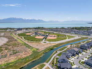 Aerial view of residential area featuring a water and mountain view, Utah Lake, ball park