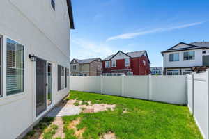 View of yard featuring a residential view and a patio