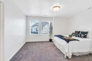 Bedroom featuring carpet floors and baseboards