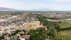 Aerial overview of property's location with a mountain backdrop and nearby suburban area