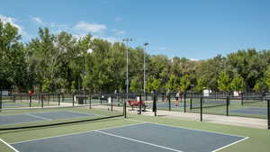 View of tennis court with community basketball court