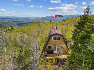 View of front of property featuring a deck with mountain view